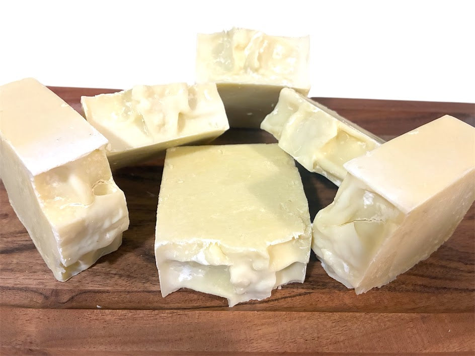 Chunks of gentle shea butter on a wooden surface