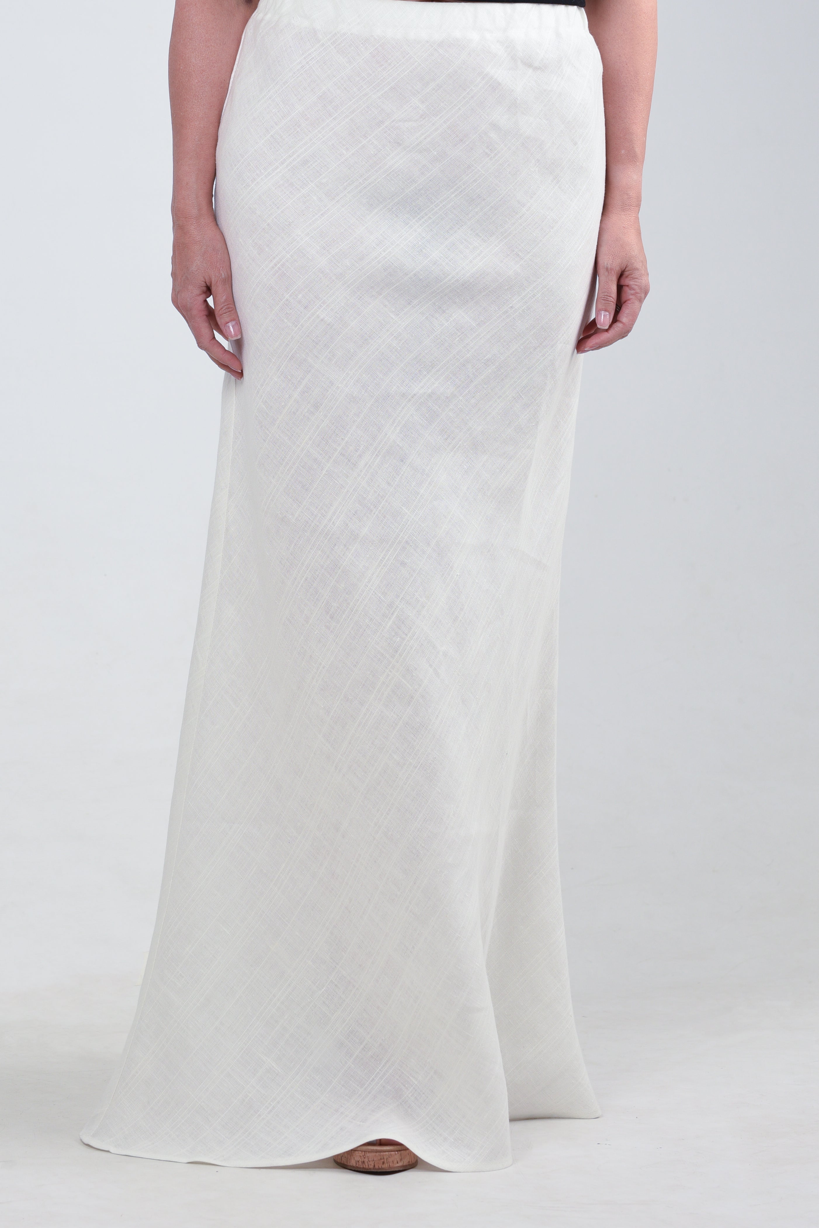 Front view of a model wearing a white maxi skirt