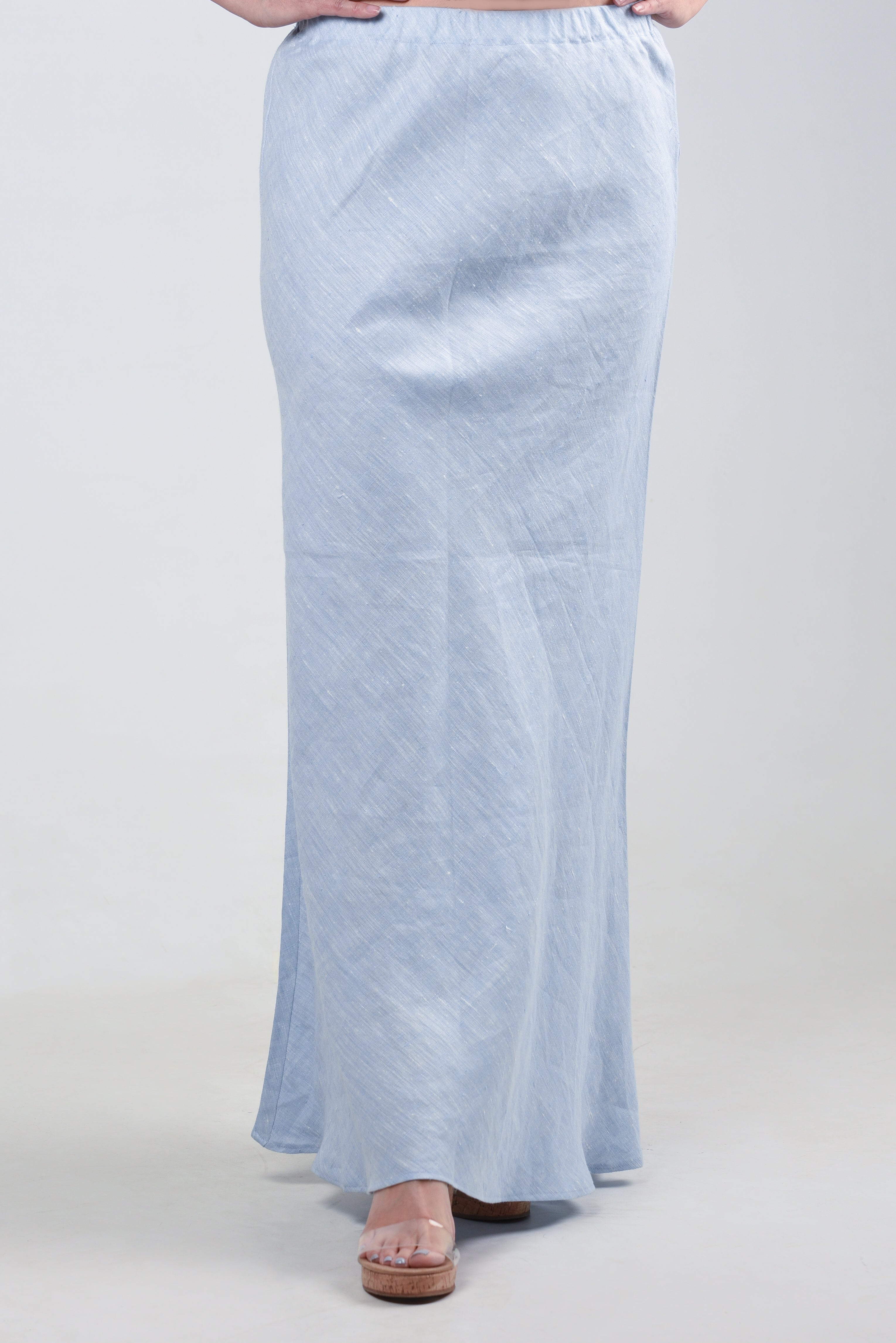 Model showcasing a light blue maxi skirt with a smooth silhouette