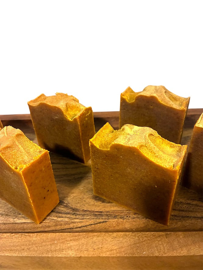 Close-up of turmeric soap bars displayed on a wooden surface