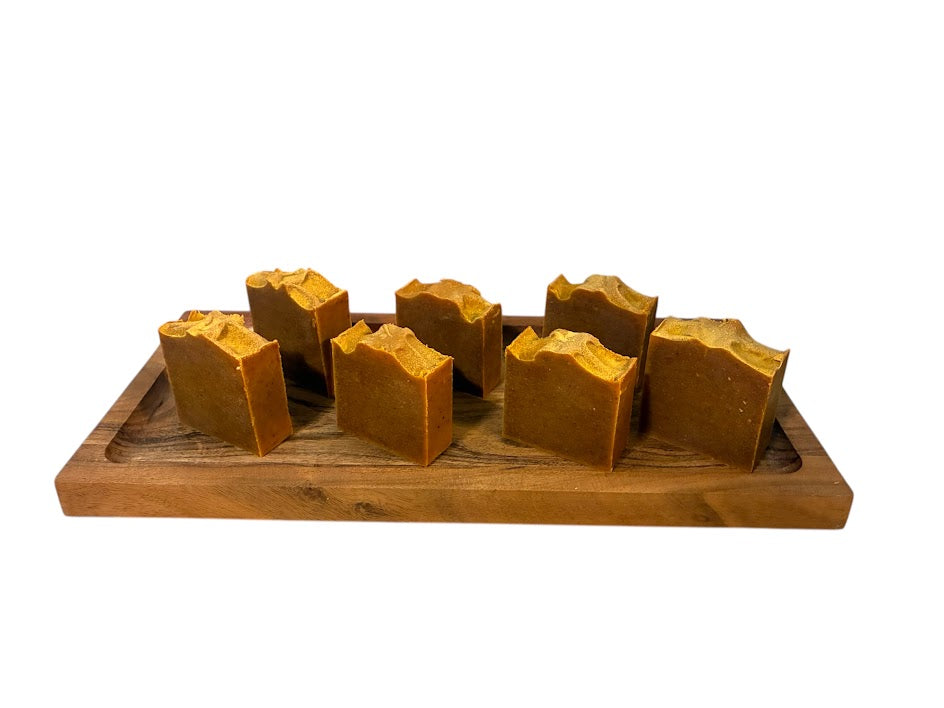 Turmeric soap bars arranged on a wooden tray